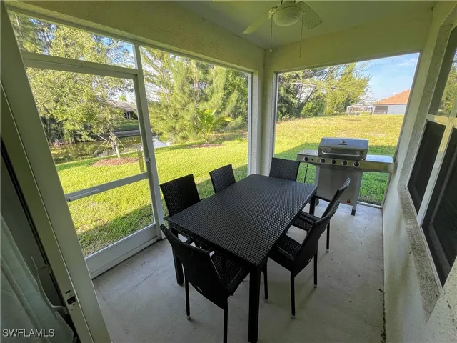 a view of a dining room with furniture and a window