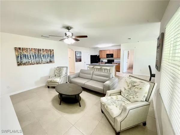 a living room with furniture and a large window