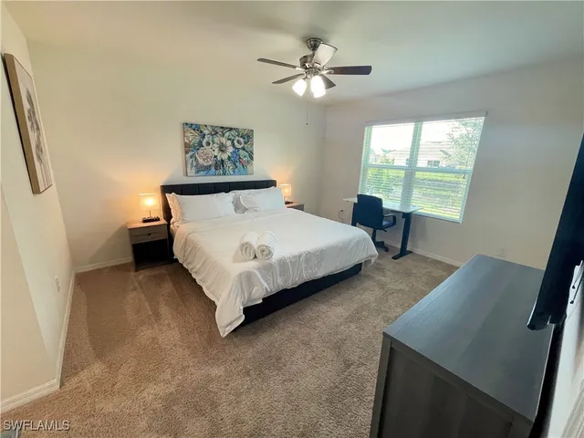 a bedroom with a bed and a table in it