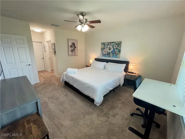 a bedroom with a bed window and a table