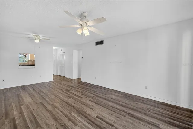 a view of an empty room and wooden floor