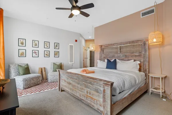 a bedroom with a bed and a flat tv screen