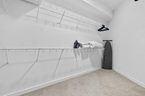 a bed room with a bed and painting on the wall