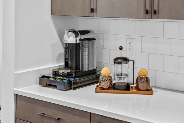 a kitchen with stainless steel appliances granite countertop a stove a sink a refrigerator and a microwave