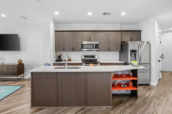 a large kitchen with a large window and stainless steel appliances