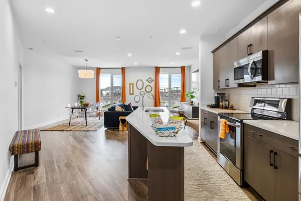 a kitchen with stainless steel appliances a microwave a stove and a refrigerator