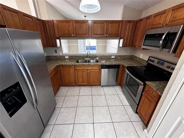 an empty room with staircase and white walls