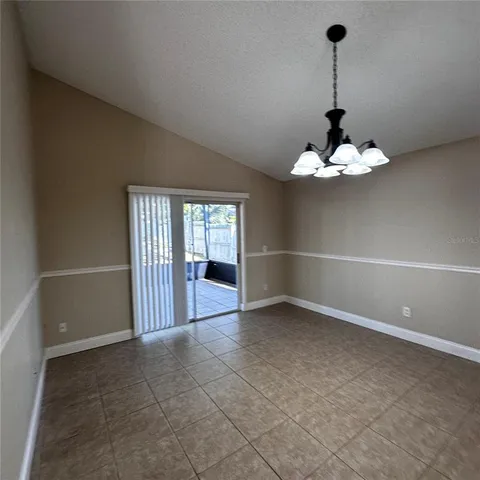 a view of a livingroom with an empty space and a staircase