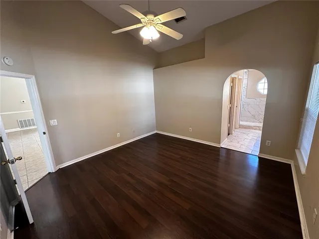 a spacious bathroom with a granite countertop sink a mirror and a bathtub