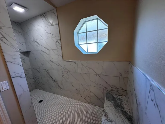 a bathroom with a bathtub and a shower