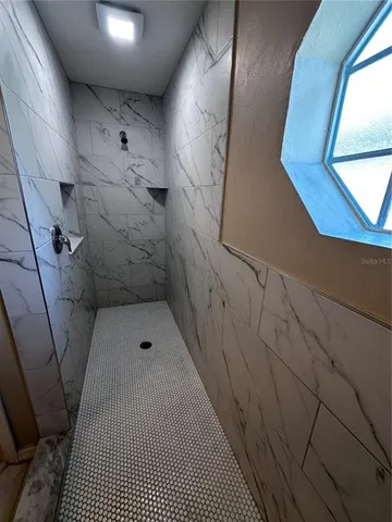 a bathroom with a sink and glass door shower