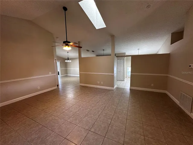 a view of a kitchen with a sink and a refrigerator