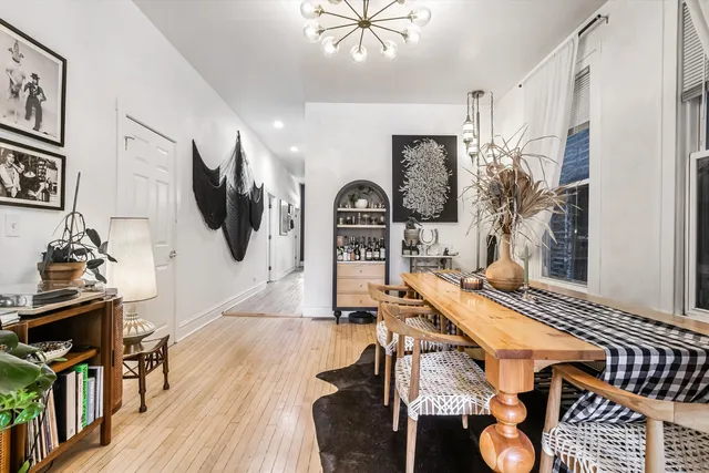 a living room with furniture a flat screen tv and a floor to ceiling window