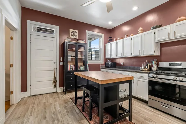 a kitchen with stainless steel appliances granite countertop a stove and a refrigerator