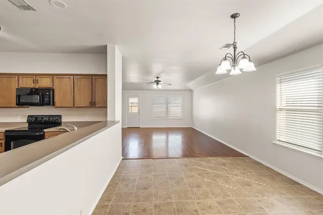 a view of a kitchen with a sink and dishwasher cabinets