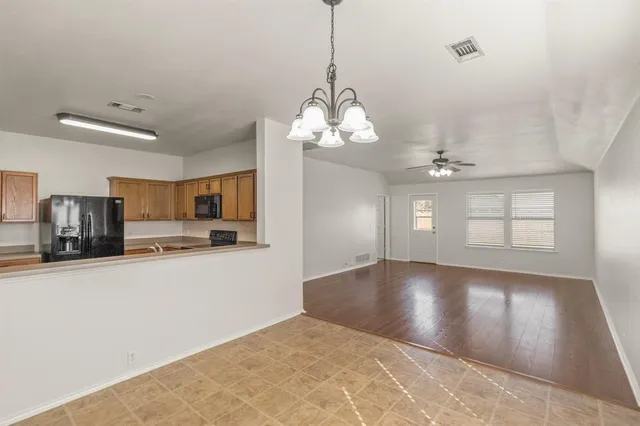a view of a livingroom with a chandelier furniture and windows
