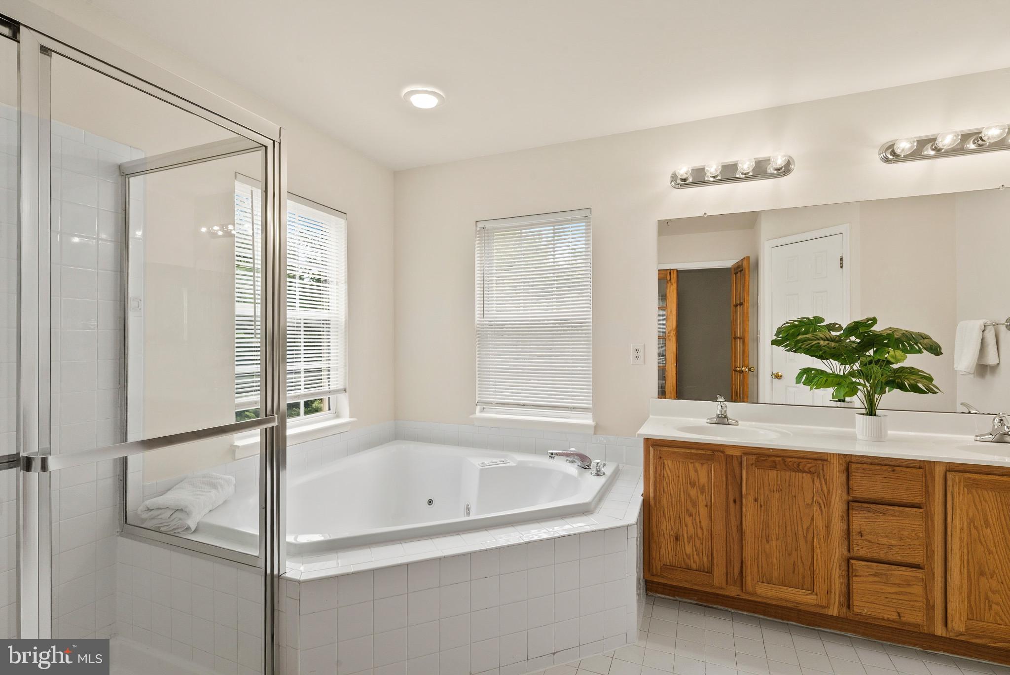 1709 Woodruff Way Frederick, MD 21701 - Photo 10 of 42 a bathroom with a tub shower and sink