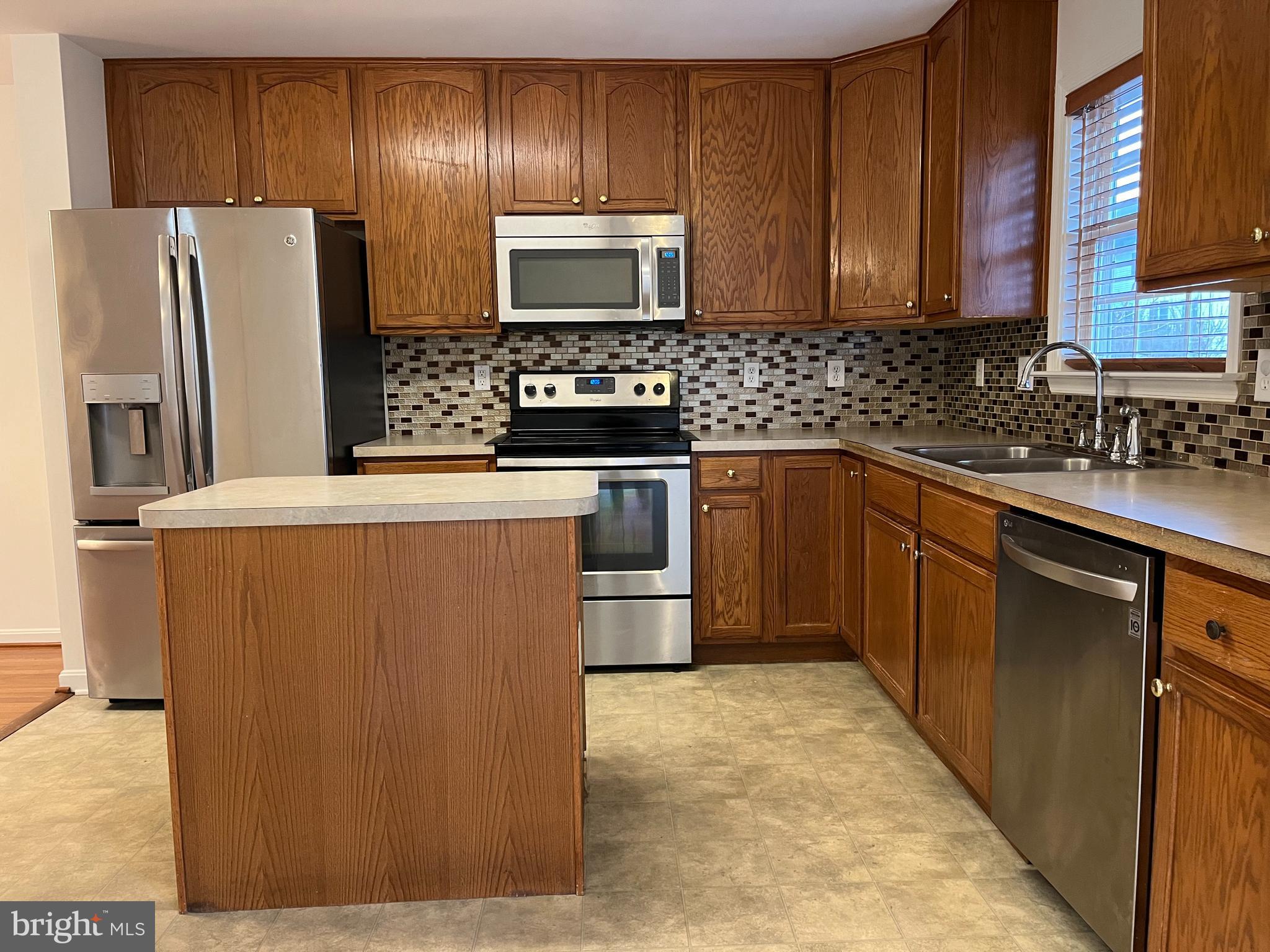20 Mabel Lane Martinsburg, WV 25404 - Photo 6 of 30 a kitchen with stainless steel appliances granite countertop a refrigerator stove a sink and dishwasher