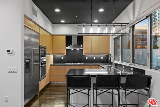 a kitchen with a table chairs refrigerator and cabinets