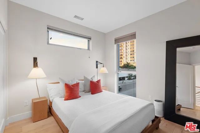 a bedroom with a bed and a lamp