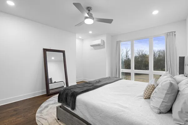 a bedroom with a bed and a large window