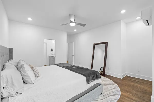 a bedroom with a bed and a mirror