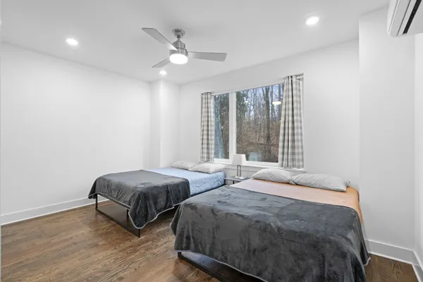 a bedroom with two beds and a large window