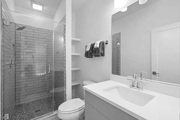 a bathroom with a sink toilet and shower