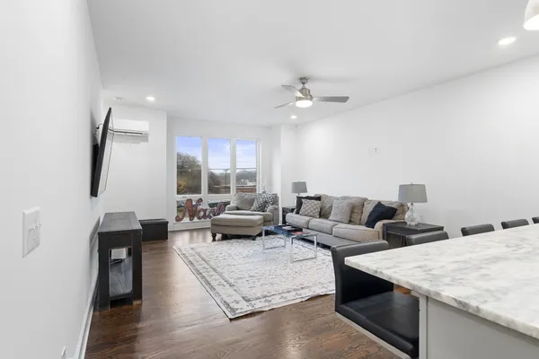 a living room with furniture and a large window