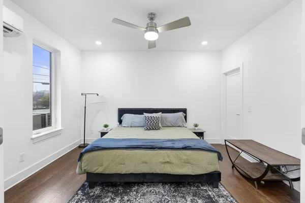 a bedroom with a bed and wooden floor