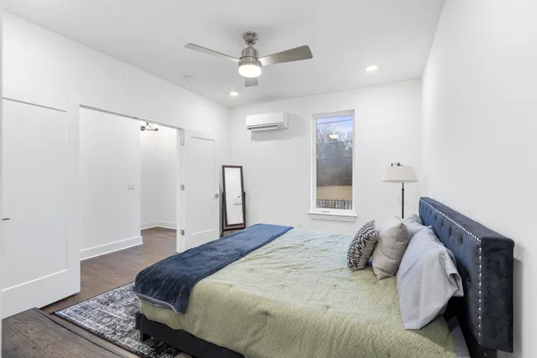a bedroom with a large bed and a chandelier