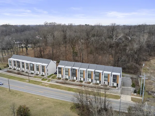 a front view of a house with a yard and balcony
