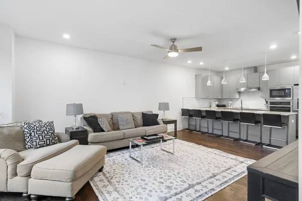 a living room with furniture and a kitchen view