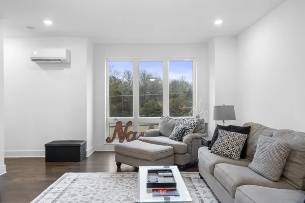a living room with furniture and a large window