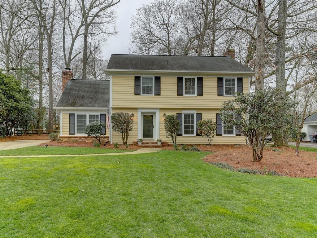 4234 Chevington Road Charlotte, NC 28226 - Photo 1 of 46 a front view of a house with a garden and trees