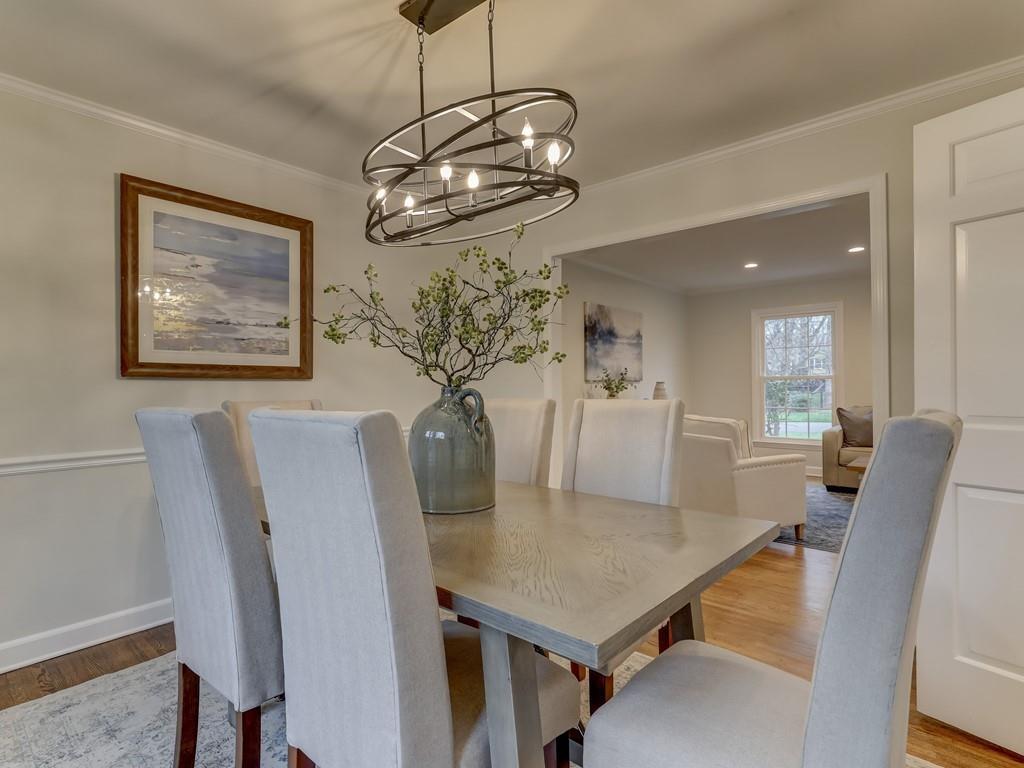 4234 Chevington Road Charlotte, NC 28226 - Photo 11 of 46 a view of a dining room with furniture and wooden floor