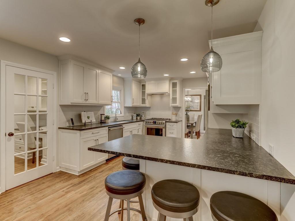 4234 Chevington Road Charlotte, NC 28226 - Photo 12 of 46 a kitchen with a table chairs sink and cabinets