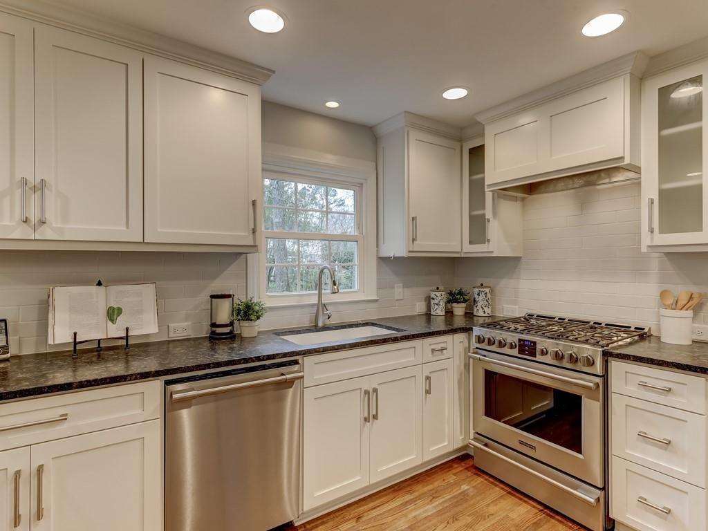 4234 Chevington Road Charlotte, NC 28226 - Photo 13 of 46 a kitchen with granite countertop a sink stainless steel appliances and cabinets