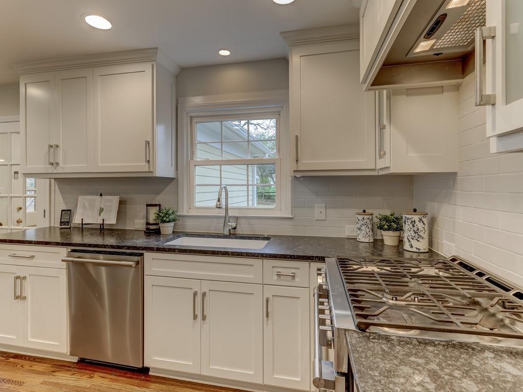4234 Chevington Road Charlotte, NC 28226 - Photo 14 of 46 a kitchen with granite countertop a sink stove and cabinets