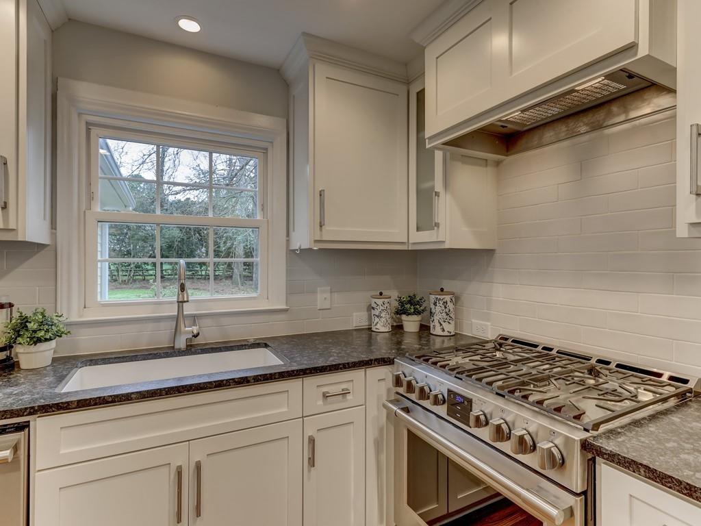 4234 Chevington Road Charlotte, NC 28226 - Photo 15 of 46 a kitchen with granite countertop a stove and a sink