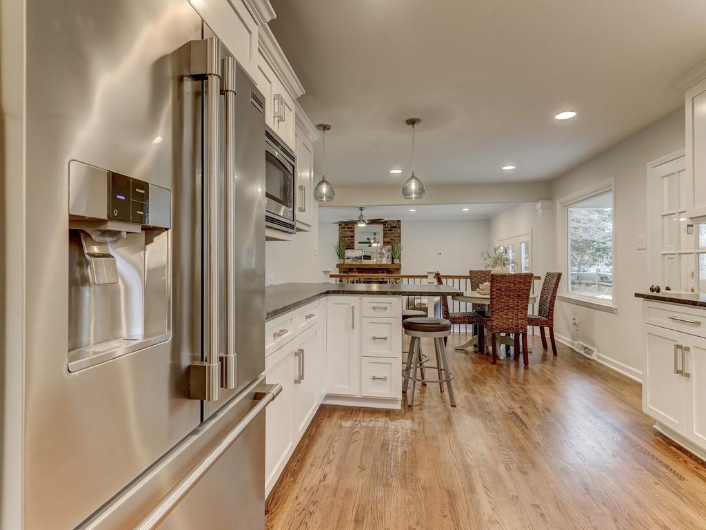 4234 Chevington Road Charlotte, NC 28226 - Photo 16 of 46 a kitchen with white cabinets and stainless steel appliances