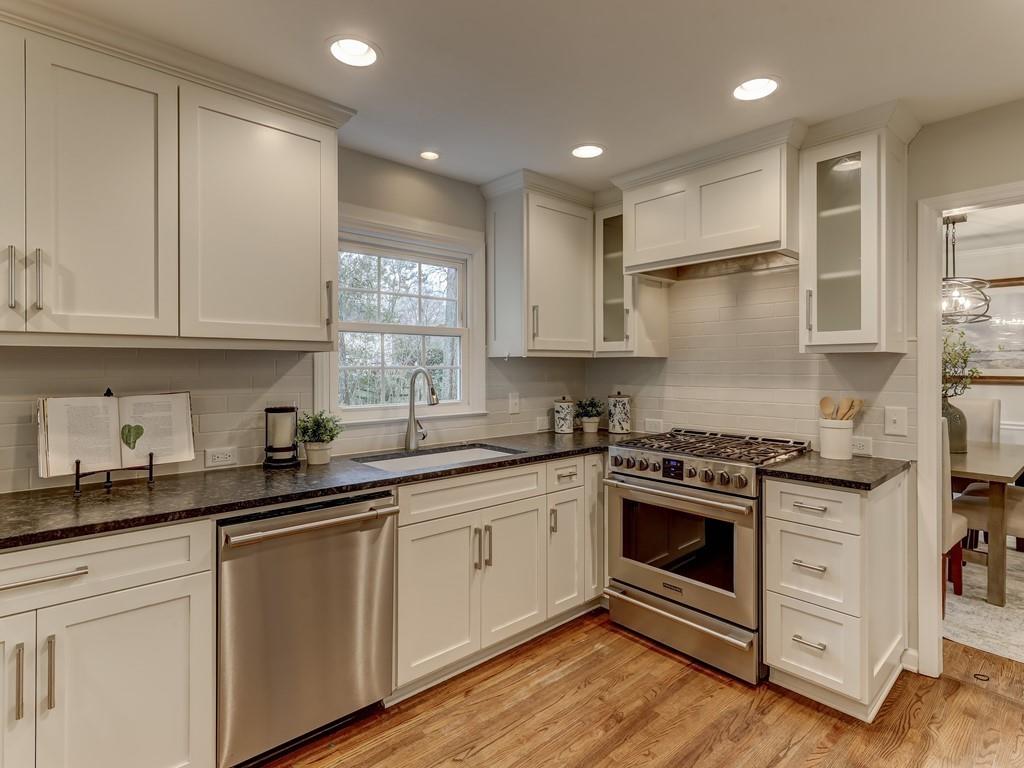4234 Chevington Road Charlotte, NC 28226 - Photo 17 of 46 a kitchen with granite countertop white cabinets and white stainless steel appliances