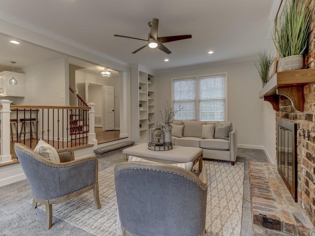 4234 Chevington Road Charlotte, NC 28226 - Photo 22 of 46 a living room with furniture a fireplace and a flat screen tv