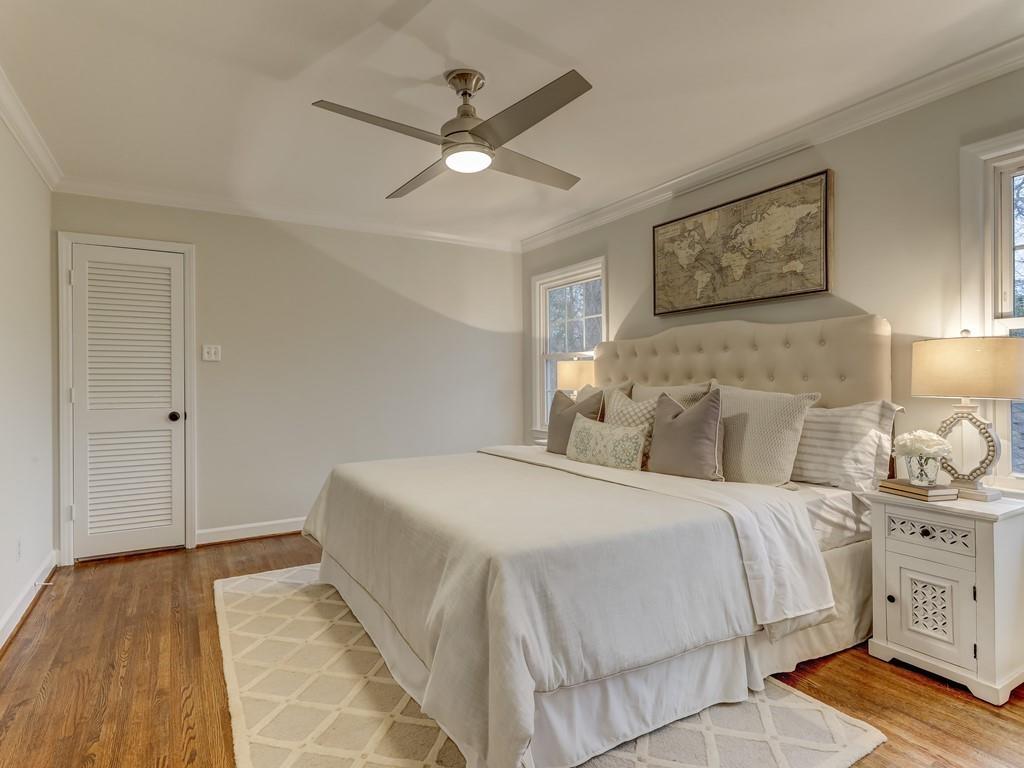 4234 Chevington Road Charlotte, NC 28226 - Photo 27 of 46 a bedroom with a large bed and a chandelier