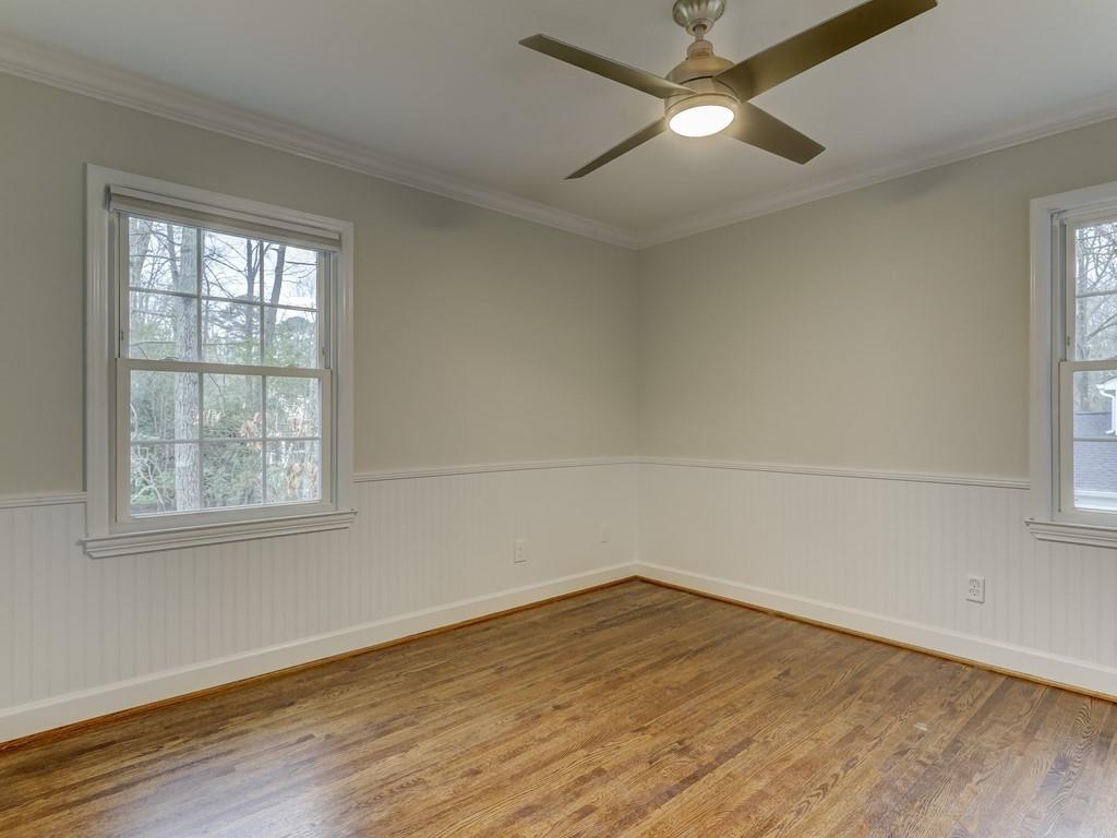 4234 Chevington Road Charlotte, NC 28226 - Photo 32 of 46 an empty room with wooden floor fan and windows