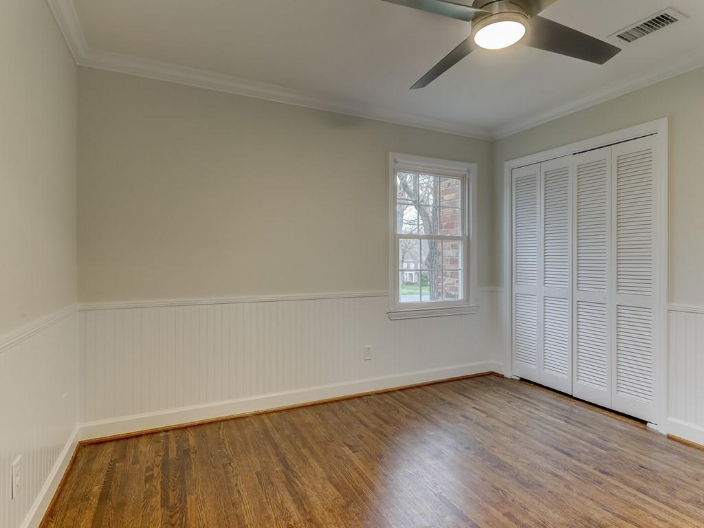 4234 Chevington Road Charlotte, NC 28226 - Photo 33 of 46 an empty room with wooden floor and windows