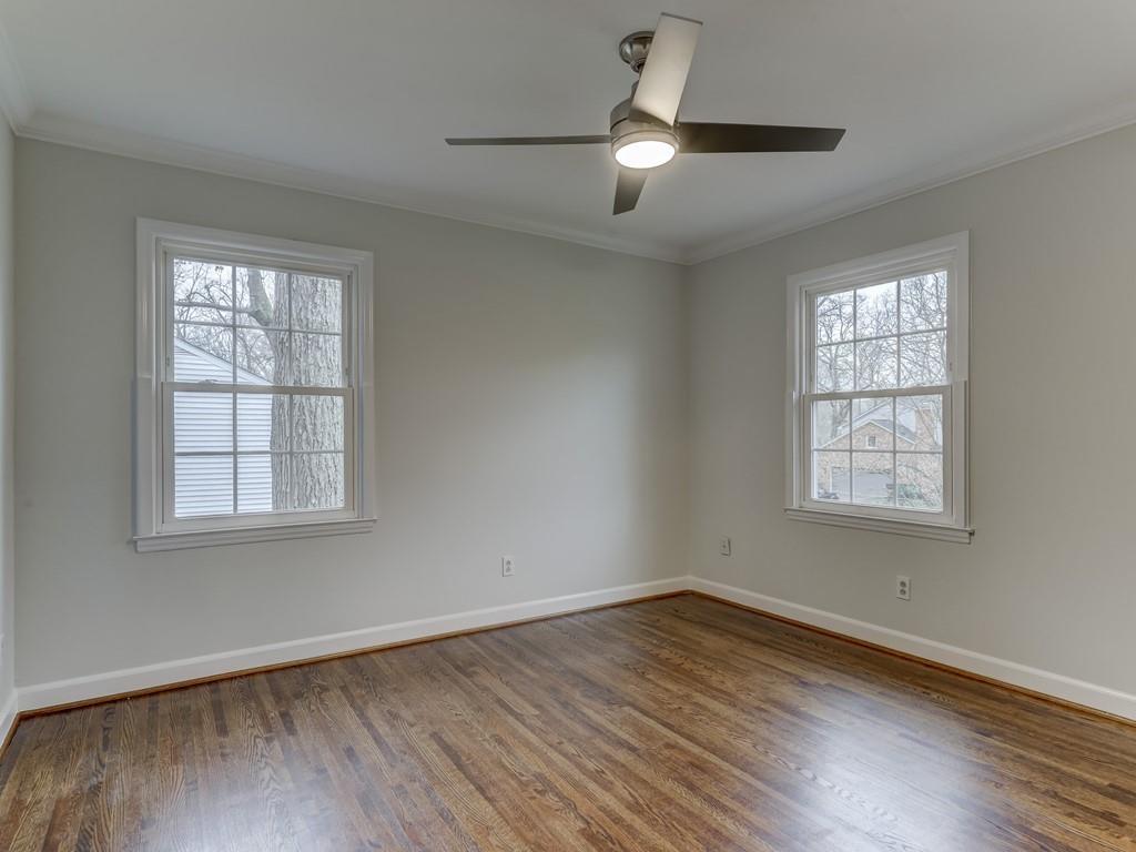 4234 Chevington Road Charlotte, NC 28226 - Photo 34 of 46 a view of an empty room with wooden floor and a window