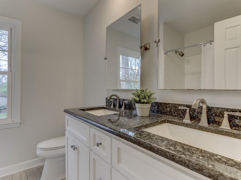 4234 Chevington Road Charlotte, NC 28226 - Photo 36 of 46 a bathroom with a granite countertop sink a toilet and mirror