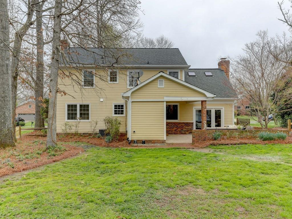 4234 Chevington Road Charlotte, NC 28226 - Photo 44 of 46 a front view of a house with a yard and trees
