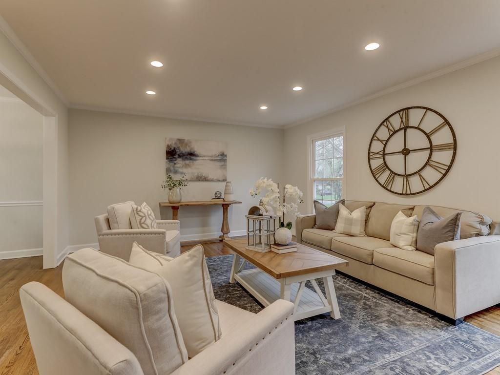 4234 Chevington Road Charlotte, NC 28226 - Photo 6 of 46 a living room with furniture a clock and a table